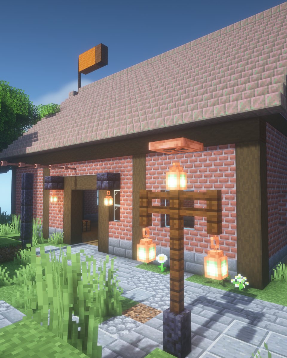 The brick warehouse with a copper roof and lamp posts