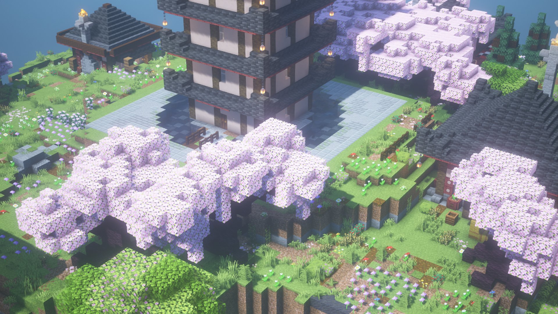 A six storey pagoda in a pond with cherry trees around it