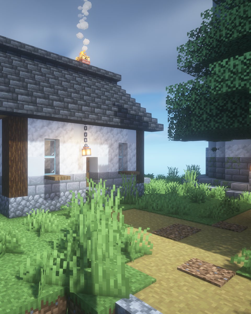 The keeper's cottage with a white wall, slate roof and smoking chimney