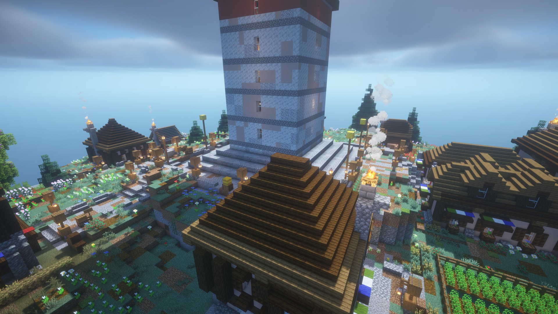 A whitewashed monastery tower above roofs and fields on a crag island